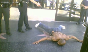 LAPD officer tases prone, unresisting man on Hollywood Blvd. on December 17, 2009.