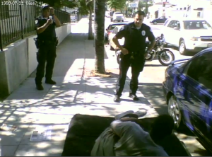 BID patrollies preparing to arrest a man for blocking the sidewalk even though he is evidently not blocking the sidewalk.  Someone would later alter the charge to conform to reality.