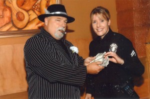 Steve Seyler of Andrews International Security, BID Patrol Pooh-bah, offers $4 to a lady cop presumably for services to be rendered.  This would be $5.20 if it were a man cop, assuming the whole 77¢ thing pans out.