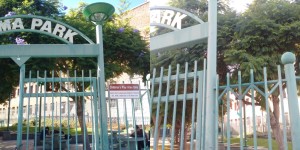 Before and after picture of the area to the right of gate.  Note unfaded paint beneath former location of sign in most recent (right-hand) picture.