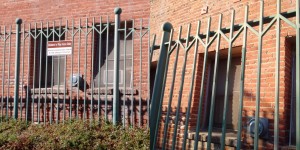 Back fence both with and without mendacious sign.  Again, note unfaded paint in former location of sign in more recent picture.  Again, click to enlarge.