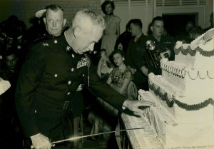 A not-so-young marine steps forward to kill and dismember a big-ass cake with a sword!  What did you do in the war, daddy?!