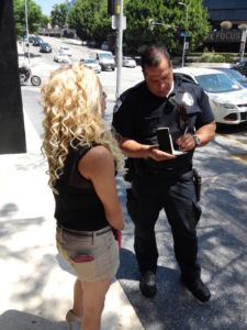 This is not a police officer, it's unregistered-with-the-police-commission BID Patrol officer M. Gomez (Badge #148) looking a lot like a police officer.