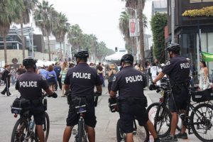 LAPD Bike officers on the Venice Boardwalk creating a chilling effect in the warm California sunshine.